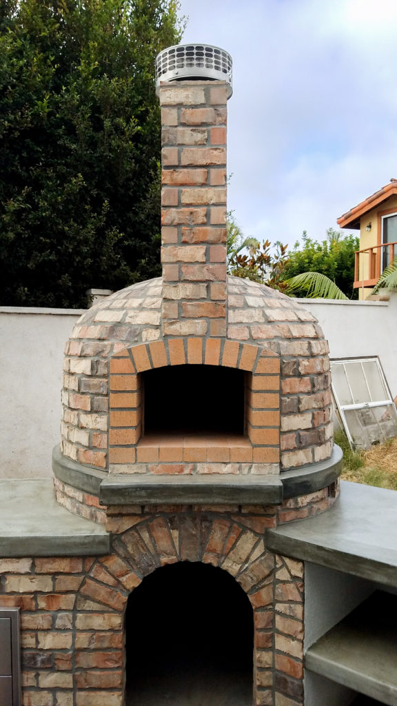 Outdoor kitchen. Custom designed gril. Real brick pizza oven. Thin brick veneer.