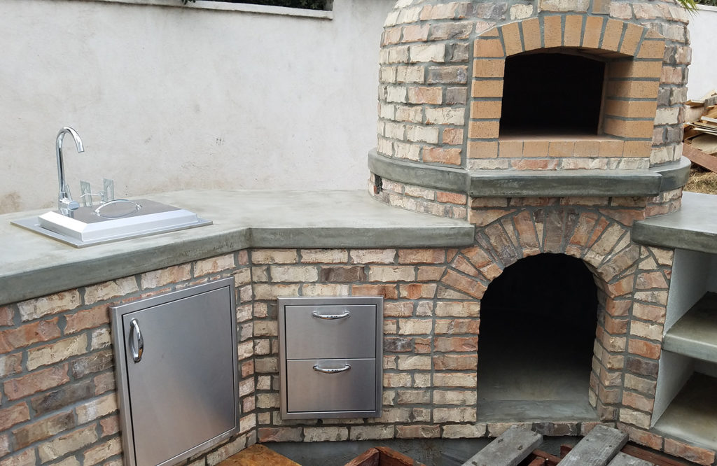 Outdoor kitchen. Custom designed gril. Real brick pizza oven. Thin brick veneer.