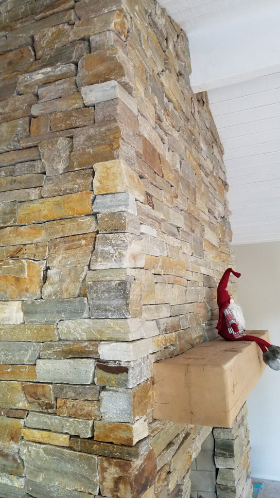 Natural Quartz stone. Stacked ledger. Dry stack veneer. Interior fireplace. Rustic wood mantel.