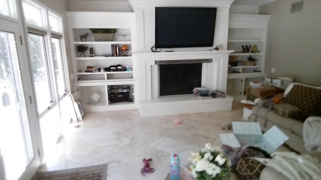 Brick hearth with custom cabinetry and fireplace surround.