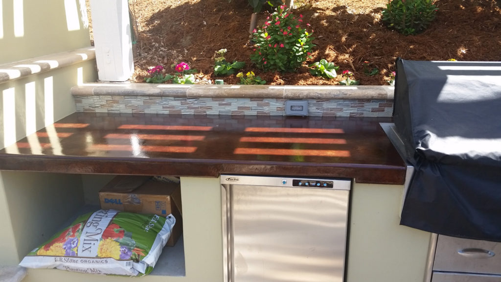 Acid stained concrete countertop. Barbecue island. Outdoor kitchen.