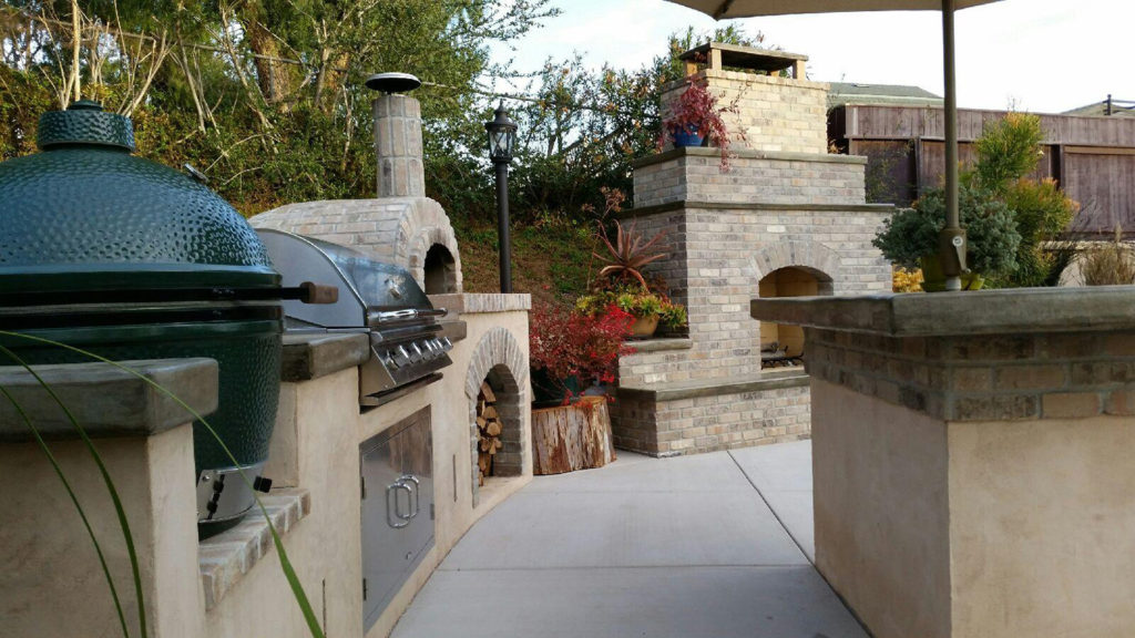 Outdoor Kitchen. Concrete counter top. Pizza oven. Outdoor fireplace. Thin brick veneer. Concrete patio.